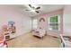 Cozy bedroom featuring plush carpeting, multiple windows, and charming decor at 3982 Ivory Gables Pl, Buford, GA 30519
