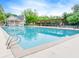 A large, inviting community pool with a pergola, clubhouse, and mature trees offers a relaxing retreat at 3982 Ivory Gables Pl, Buford, GA 30519