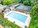 Aerial view of a community pool, tennis courts, and parking, surrounded by greenery and foliage at 3982 Ivory Gables Pl, Buford, GA 30519