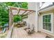 Outdoor deck space, featuring an awning, a grill and wooden chairs at 3982 Ivory Gables Pl, Buford, GA 30519