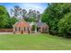 Charming brick home featuring a well-manicured lawn and inviting front entrance at 3982 Ivory Gables Pl, Buford, GA 30519