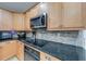 Close up on kitchen counter with wooden cabinets, modern appliances and tile backsplash at 3982 Ivory Gables Pl, Buford, GA 30519