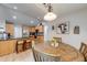 Eat-in kitchen with granite countertops, light wood cabinetry, and a dining area at 3982 Ivory Gables Pl, Buford, GA 30519