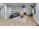 Bright living room boasts wood floors, fireplace, ceiling fan, and large windows at 3982 Ivory Gables Pl, Buford, GA 30519