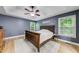 Main bedroom features a tray ceiling, ceiling fan, and natural light through two windows at 3982 Ivory Gables Pl, Buford, GA 30519