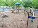 A modern community playground with a climbing wall, picnic table, and swings for neighborhood children at 3982 Ivory Gables Pl, Buford, GA 30519