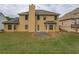 Home exterior with a well-maintained backyard featuring lush green lawn, mature trees and a partial view of a neighbor at 4952 Terrace Dr, Ellenwood, GA 30294