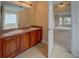 Bathroom featuring double sinks, tiled floor, and a view into the Primary bedroom at 4952 Terrace Dr, Ellenwood, GA 30294