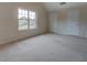 Bedroom with carpet and a window with a view of the neighboring houses at 4952 Terrace Dr, Ellenwood, GA 30294