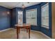 Dining area with table underneath two pendant lights and three windows overlooking backyard at 4952 Terrace Dr, Ellenwood, GA 30294