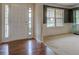 Bright entryway with wood floors and a front door with glass sidelights, leading to a carpeted living area at 4952 Terrace Dr, Ellenwood, GA 30294