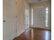 Inviting entryway featuring hardwood floors and a white front door with sidelights for natural light at 4952 Terrace Dr, Ellenwood, GA 30294