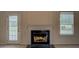 Cozy fireplace with a white mantel, complemented by natural light from a nearby window and door at 4952 Terrace Dr, Ellenwood, GA 30294