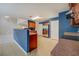Open kitchen features blue walls, stainless steel appliances, and dark wood cabinets at 4952 Terrace Dr, Ellenwood, GA 30294