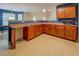 Kitchen with lots of wooden cabinets, tan countertops, tile flooring, stainless microwave and blue and white walls at 4952 Terrace Dr, Ellenwood, GA 30294