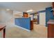 Kitchen with views to living and dining areas, stainless steel refrigerator and breakfast bar at 4952 Terrace Dr, Ellenwood, GA 30294