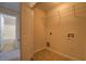 Small laundry room with tile flooring includes washer hookups and a metal storage rack at 4952 Terrace Dr, Ellenwood, GA 30294