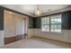 Living room featuring wainscoting, large window, and view to additional rooms at 4952 Terrace Dr, Ellenwood, GA 30294