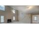 Living room featuring a fireplace, tall windows, and a doorway to the backyard, ideal for relaxation at 4952 Terrace Dr, Ellenwood, GA 30294