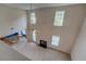 Bright and airy living room with high ceilings, a fireplace, and open access to the kitchen area at 4952 Terrace Dr, Ellenwood, GA 30294