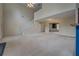 Spacious living area with a staircase, fireplace, and open access to other rooms, offering a versatile layout at 4952 Terrace Dr, Ellenwood, GA 30294
