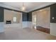 Open living room features wainscoting, fireplace, and entrance to additional rooms at 4952 Terrace Dr, Ellenwood, GA 30294