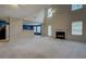 Spacious living room with a fireplace, high ceilings, and abundant natural light from large windows at 4952 Terrace Dr, Ellenwood, GA 30294