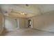 Large main bedroom with a tray ceiling, carpeted floors, and access to an en-suite bathroom and closet at 4952 Terrace Dr, Ellenwood, GA 30294