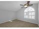 This bedroom features neutral paint, carpet, ceiling fan, and natural light from the window at 1038 Seven Springs Cir, Marietta, GA 30068
