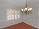 Dining area featuring hardwood floors, chandelier, and window with shutters at 1038 Seven Springs Cir, Marietta, GA 30068