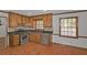 This is a kitchen with light wood cabinets, stainless steel appliances, and stone backsplash at 1038 Seven Springs Cir, Marietta, GA 30068