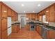 Kitchen features wood cabinets, stainless steel appliances and hardwood floors at 1038 Seven Springs Cir, Marietta, GA 30068
