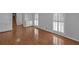 Living room with hardwood floors, built-in shelving and two windows at 1038 Seven Springs Cir, Marietta, GA 30068
