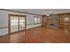 Spacious living room boasts hardwood floors, a brick fireplace, built-in shelving, and sliding door access to outdoors at 1038 Seven Springs Cir, Marietta, GA 30068