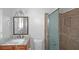 This bathroom features a vanity with granite countertop, a glass shower, and neutral tile at 1038 Seven Springs Cir, Marietta, GA 30068