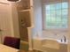Bathroom features a garden tub with a view of nature and a separate shower stall at 27 Edgar Ct, Hiram, GA 30141