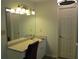 Bathroom vanity with white cabinets and a large mirror complemented by a light fixture at 27 Edgar Ct, Hiram, GA 30141