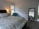 Comfortable bedroom featuring a reading chair, a large window view, and a decorative full-length mirror at 27 Edgar Ct, Hiram, GA 30141