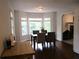 Dining room area filled with natural light, with view into living room with fireplace at 27 Edgar Ct, Hiram, GA 30141