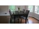 Dining Room features a dining table with seating for four, set next to large bright windows at 27 Edgar Ct, Hiram, GA 30141