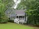 Charming two-story home with a landscaped yard and inviting front porch, surrounded by mature trees at 27 Edgar Ct, Hiram, GA 30141