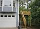Home's exterior featuring a garage and wooden deck, providing an additional outdoor space at 27 Edgar Ct, Hiram, GA 30141