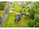 Aerial view of a home with a spacious yard, nearby roundabout, and surrounding greenery offering a serene setting at 336 Burnt Hickory Rd, Powder Springs, GA 30127