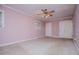 Bedroom with pink walls, carpeted floors, a ceiling fan and a window at 336 Burnt Hickory Rd, Powder Springs, GA 30127