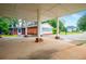 View from the carport showing a detached brick house in the background at 336 Burnt Hickory Rd, Powder Springs, GA 30127