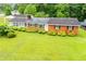 Charming one-story brick home with a well-manicured lawn and verdant bushes at 336 Burnt Hickory Rd, Powder Springs, GA 30127
