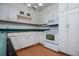 Traditional kitchen with white cabinets and laminate flooring at 336 Burnt Hickory Rd, Powder Springs, GA 30127