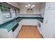 Traditional kitchen with white cabinets, a laminate floor, and bright lighting at 336 Burnt Hickory Rd, Powder Springs, GA 30127