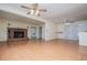 Living room with a brick fireplace, laminate floors and view into another room at 336 Burnt Hickory Rd, Powder Springs, GA 30127