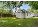 Spacious backyard with a well-maintained lawn, mature trees and the side view of the house at 94 Glenn Se St, Atlanta, GA 30312
